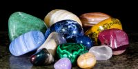 Collection and mix of colorful trumbled mineral stones, gemstones and healing stones